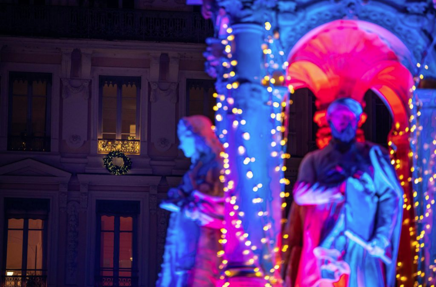 Light performers in costume during Lyon’s Festival of Lights, merging art, technology, and performance.