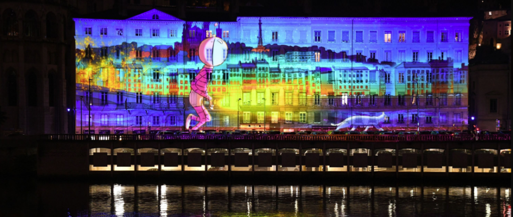 Colorful light projection reflected on the Saône River during Lyon’s Festival of Lights.